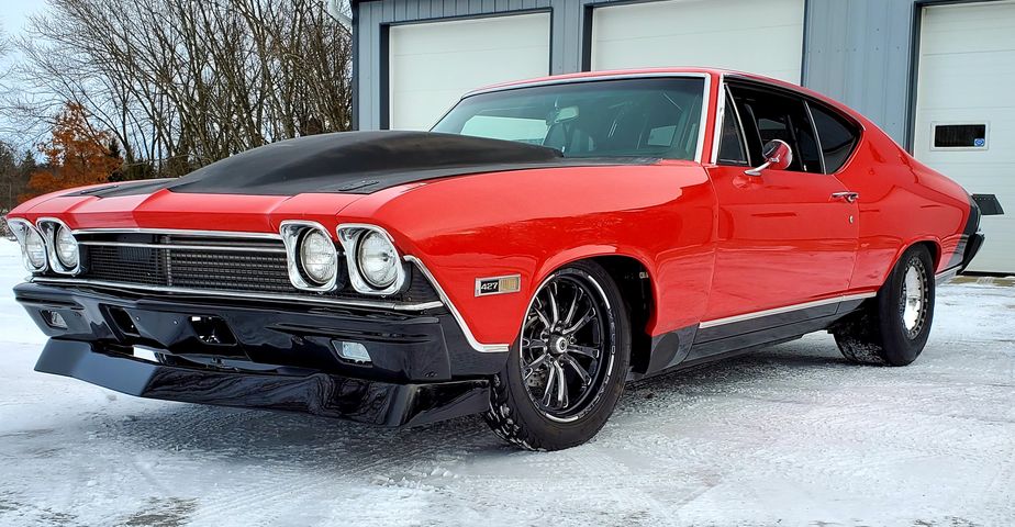 A Red Color Chevelle Car With Fiberglass Hood