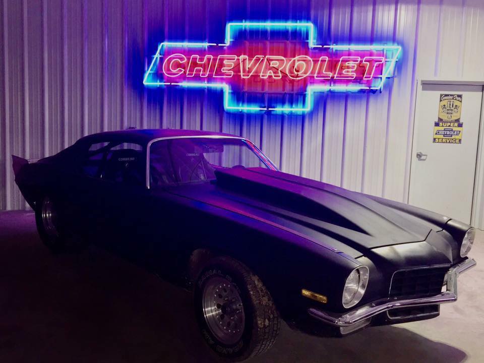 A Black Color Chevrolet Car in a Metal Garage